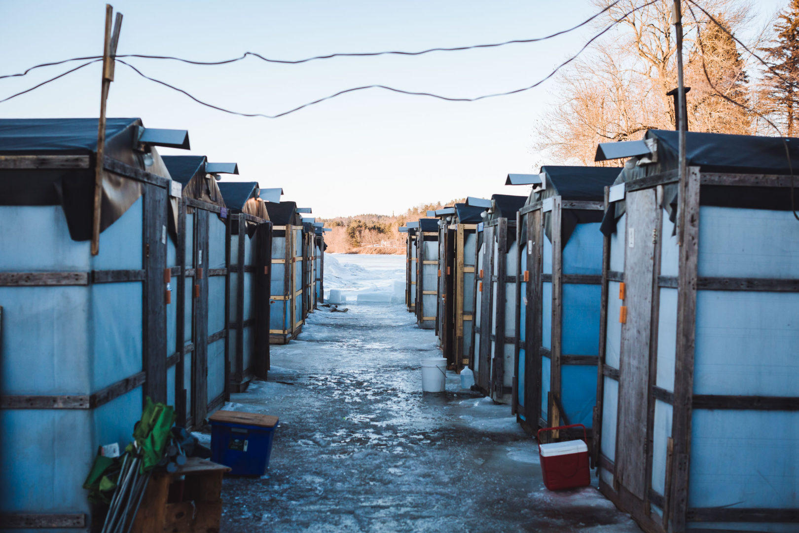 Smelting shacks lined up on the ice of a frozen lake in Maine