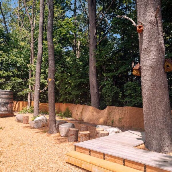 Backyard-7 (1) A view of the Backyard area, trees, stones, and picnic tables at Allagash Brewing Company