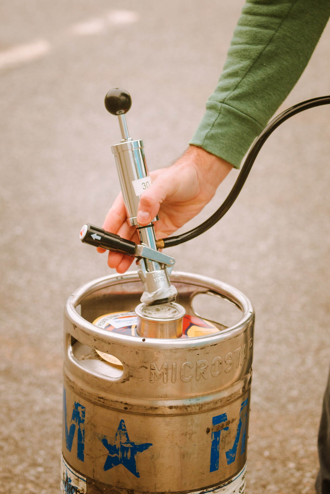 demonstration of tapping a keg. Lift the handle to disengage.