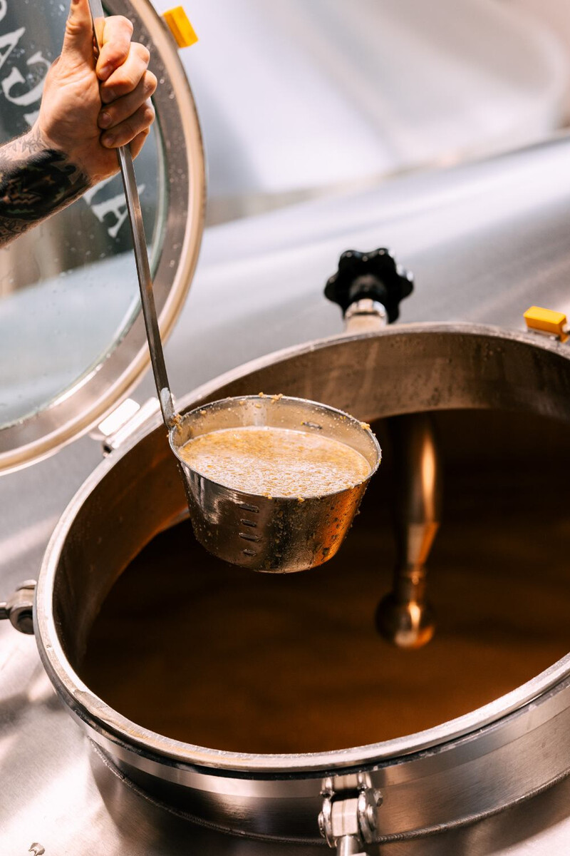 A ladle full of grain and water.