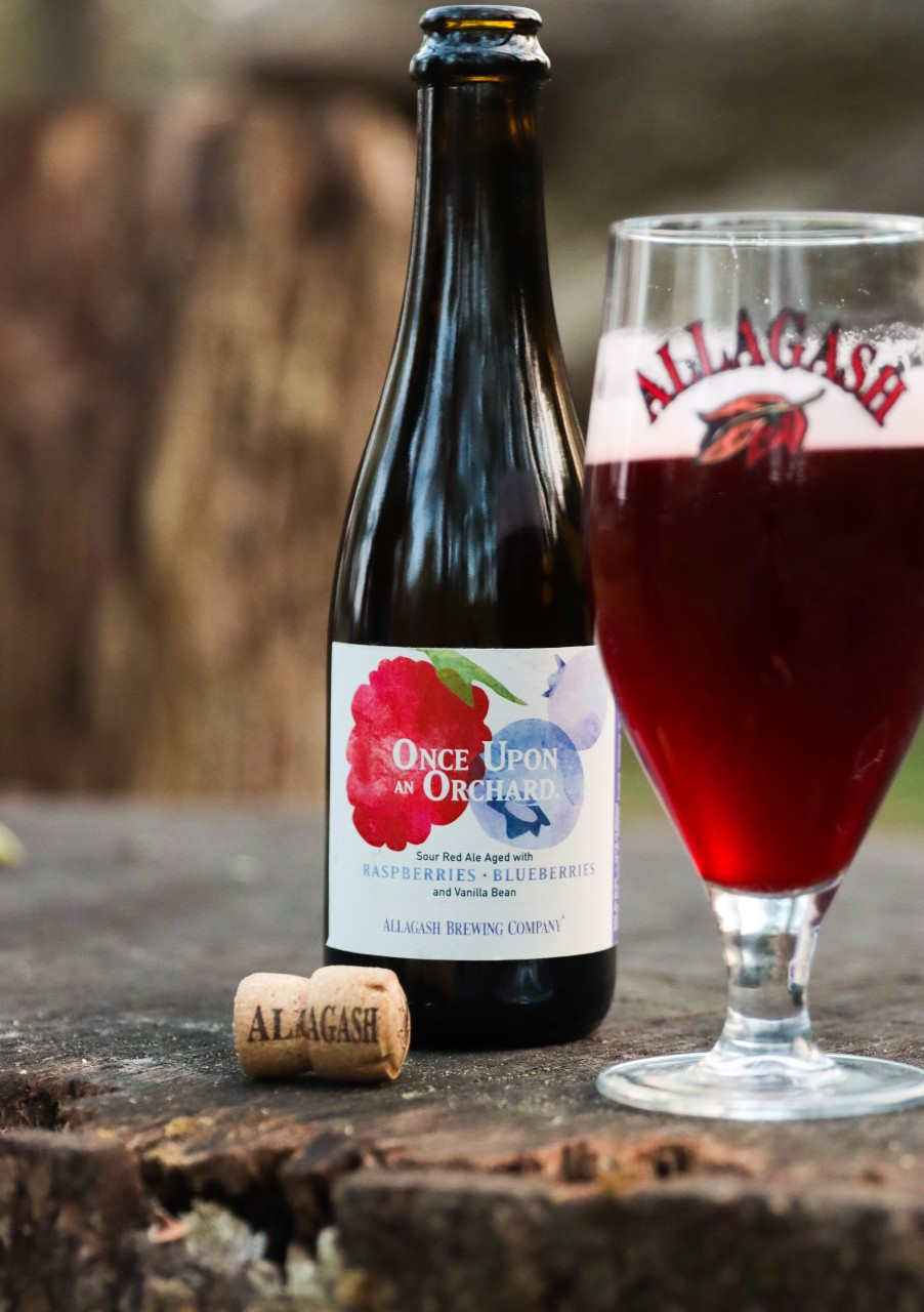 Allagash Once Upon an Orchard: cherries, raspberries and vanilla sitting on a stump