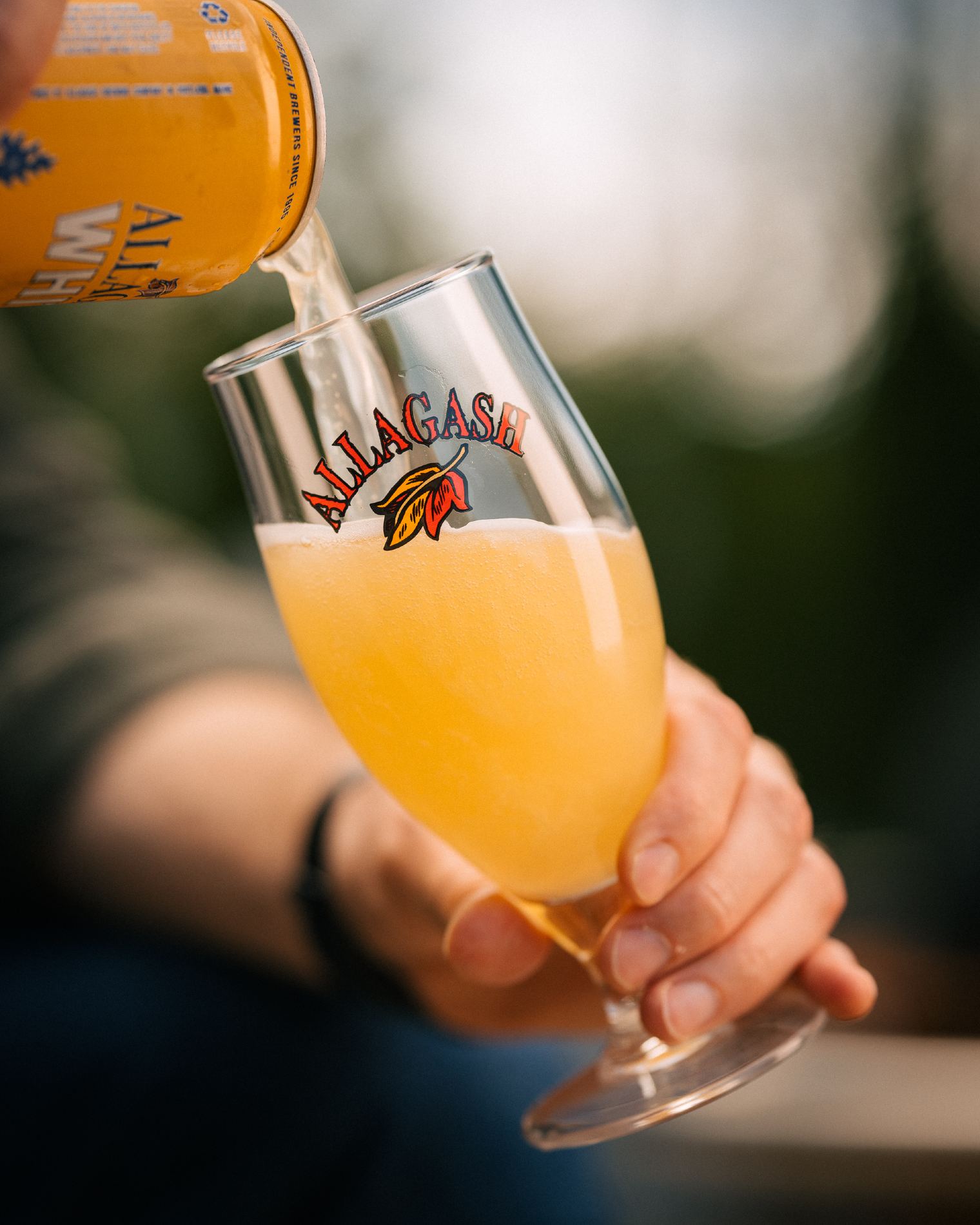 Person pouring a can of Allagash White