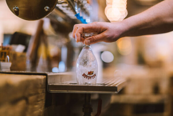 Person holding a chalice to our glass rinser