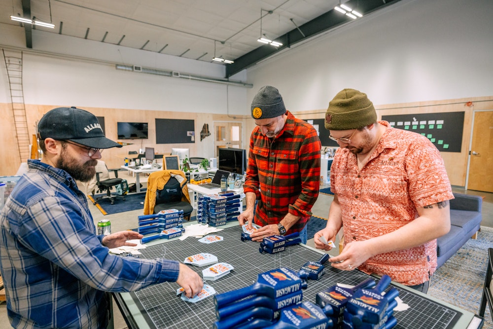 Affixing stickers to tap handles for the Allagash House Series