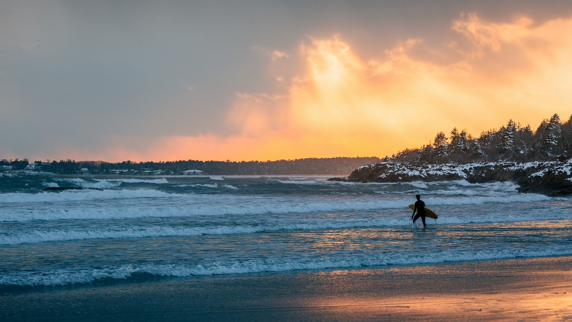 Beach at sunrise, with surfer.