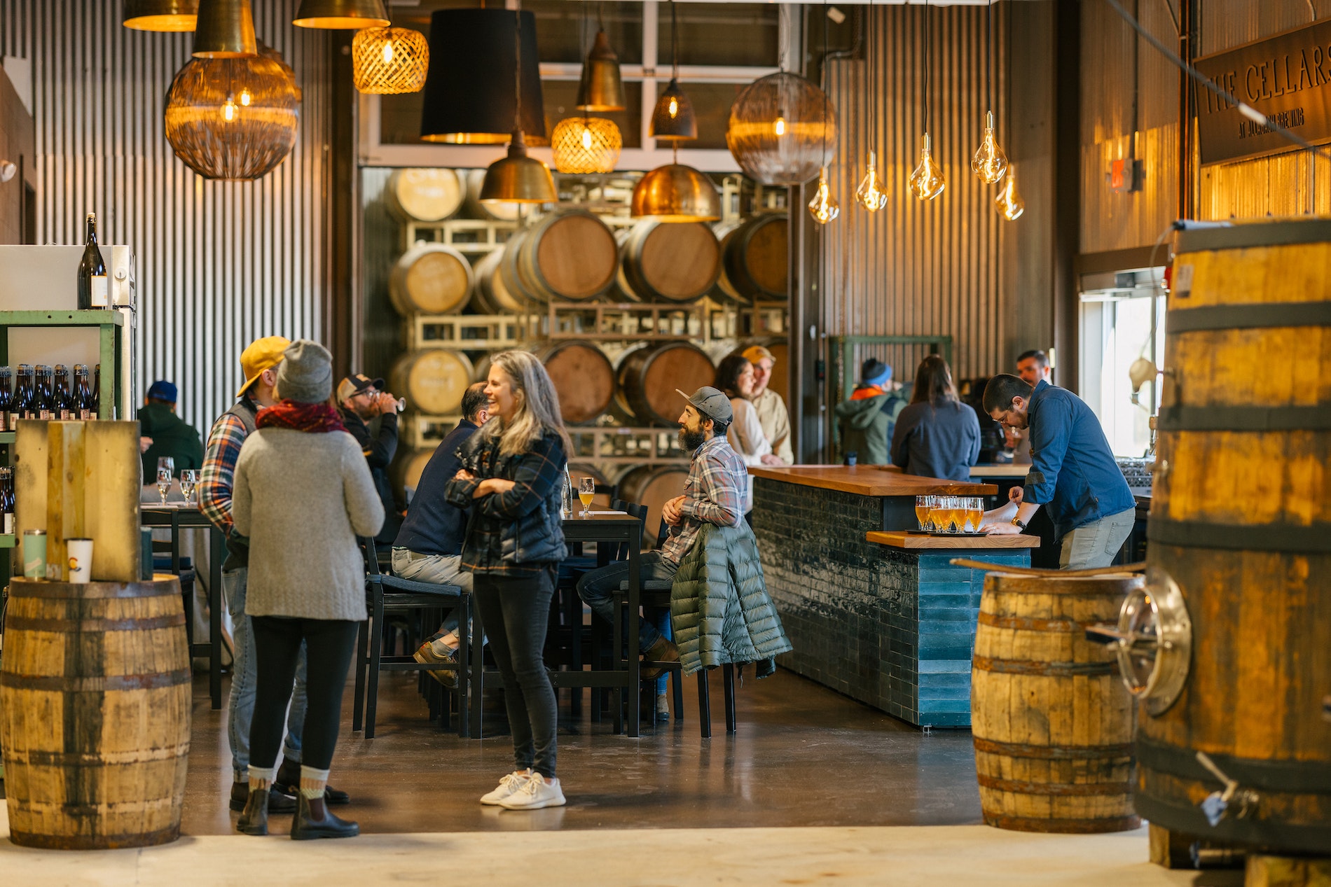 A look at people enjoying a beer tasting inside The Cellars at Allagash