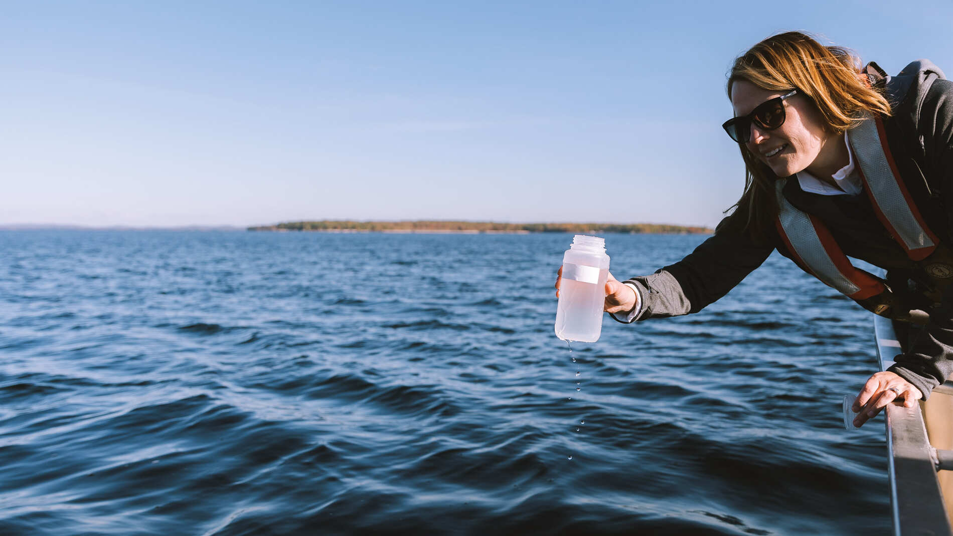 Pulling a water sample from Sebago Lake